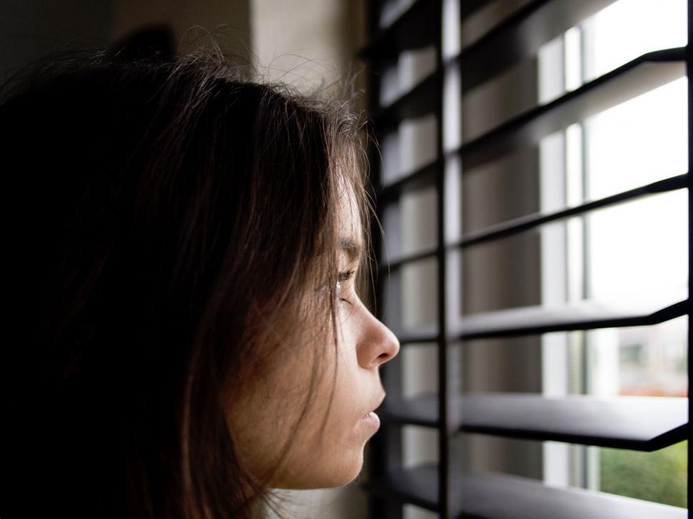 Free Image of A person looking out of the window 