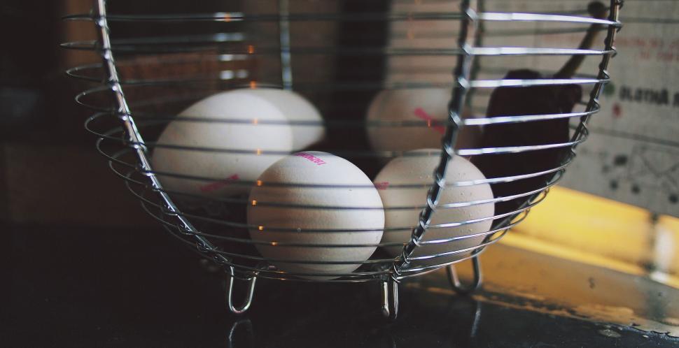 Free Image of Eggs in a metal basket on a counter 