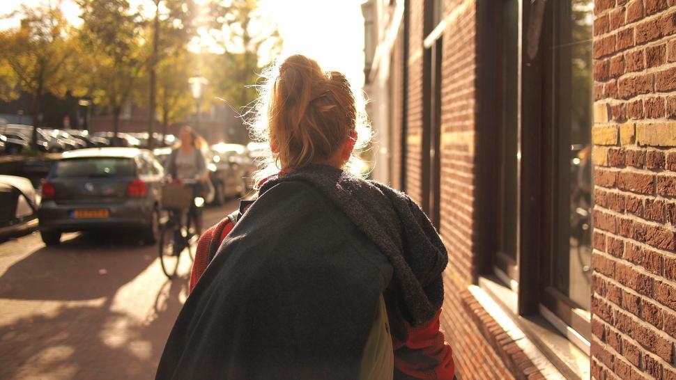 Free Image of Back of a woman by the sunny street 