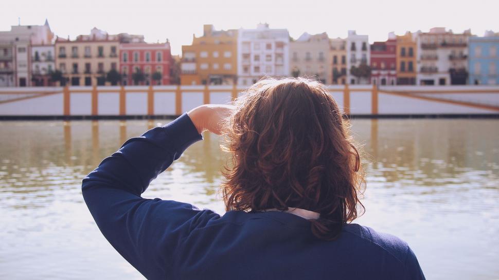 Free Image of Person overlooking colorful waterfront buildings 
