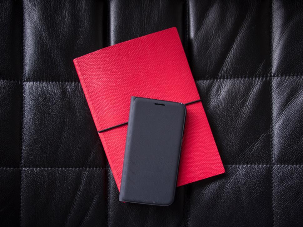 Free Image of Smartphone and notebook on leather texture 