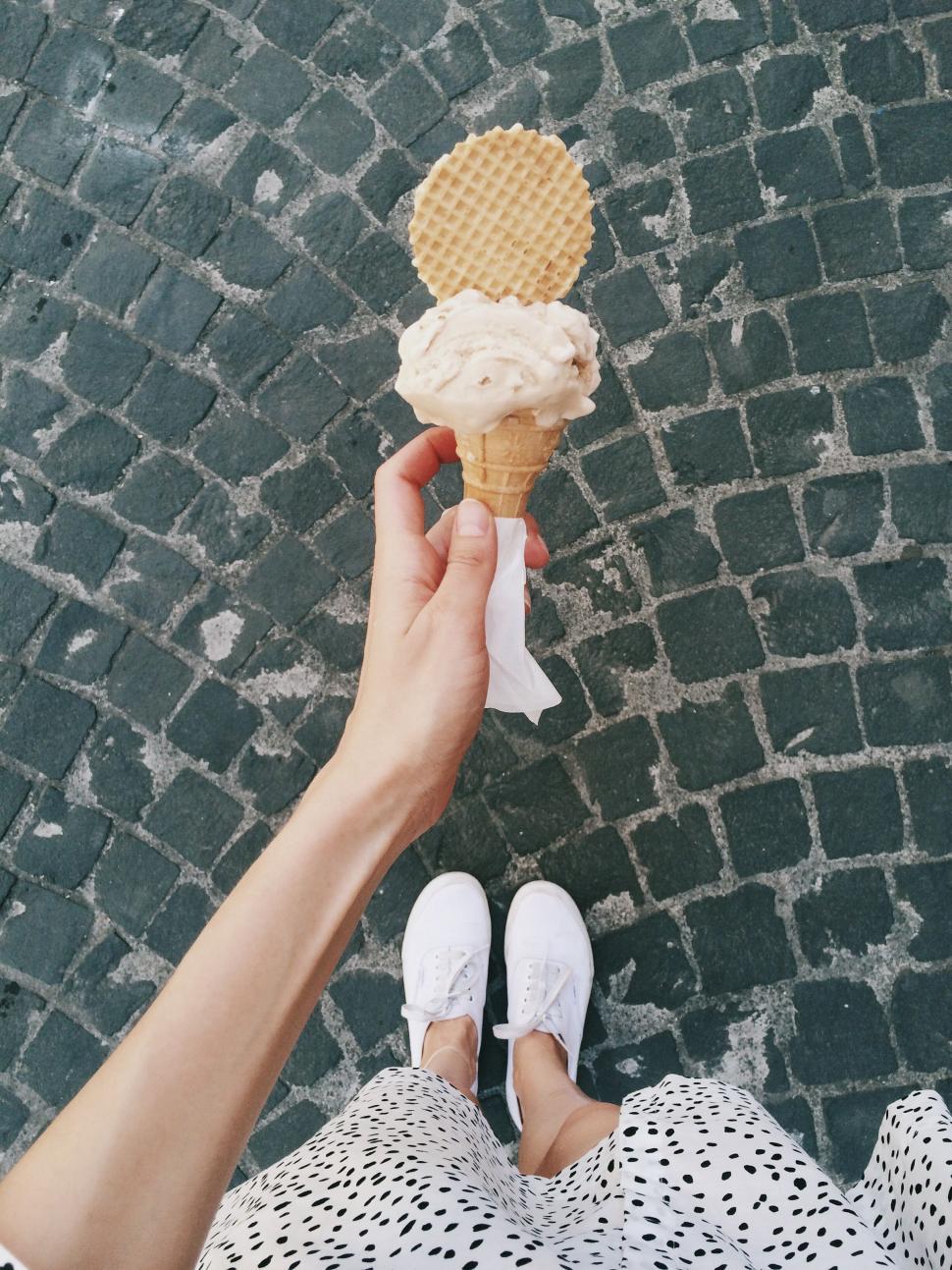 Free Image of Point of view hand holding an ice cream 