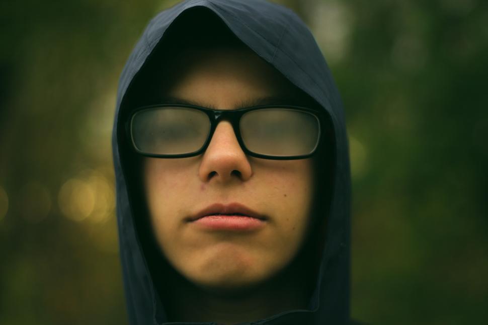 Free Image of Close-up of hooded teenager with glasses 