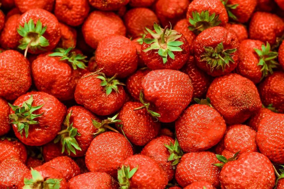 Free Image of Fresh strawberries pile in vivid detail 
