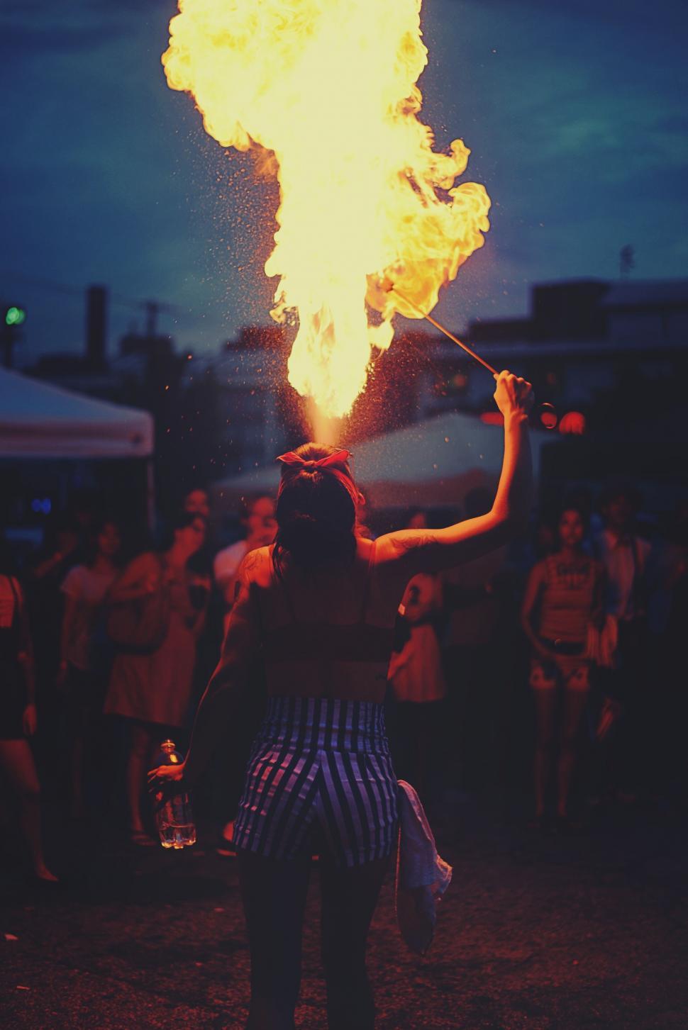 Free Image of Fire performer in front of twilight crowd 