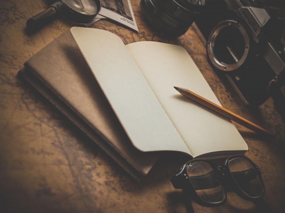 Free Image of Open notebook with blank pages on a wooden desk 