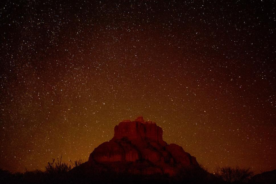 Free Image of Starry Sky Over Rock Formation at Night 