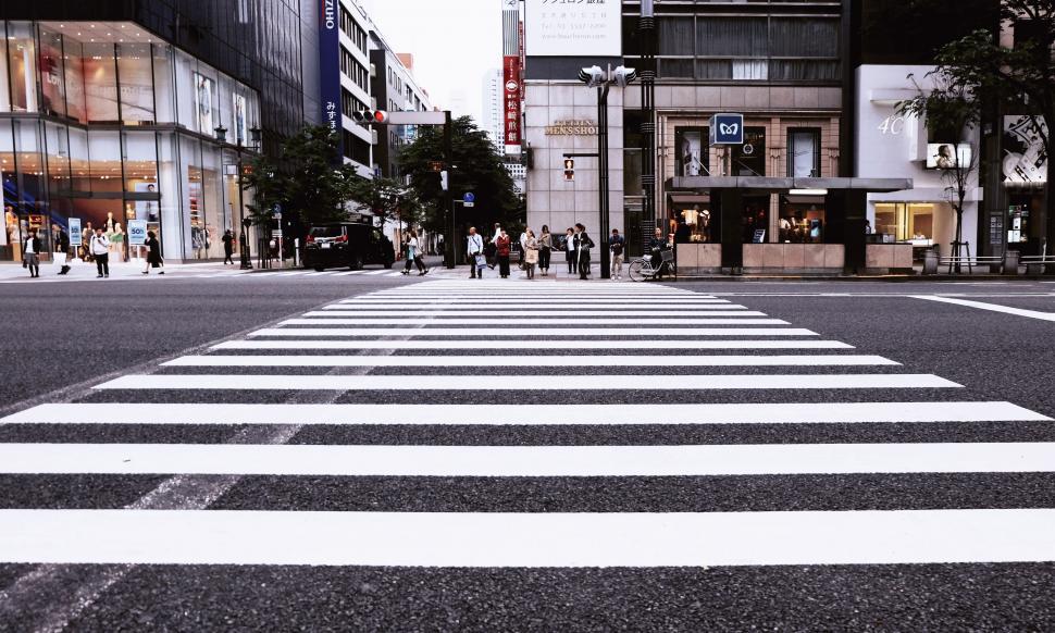 Free Image of Pedestrians Crossing a Wide City Zebra Crossing 