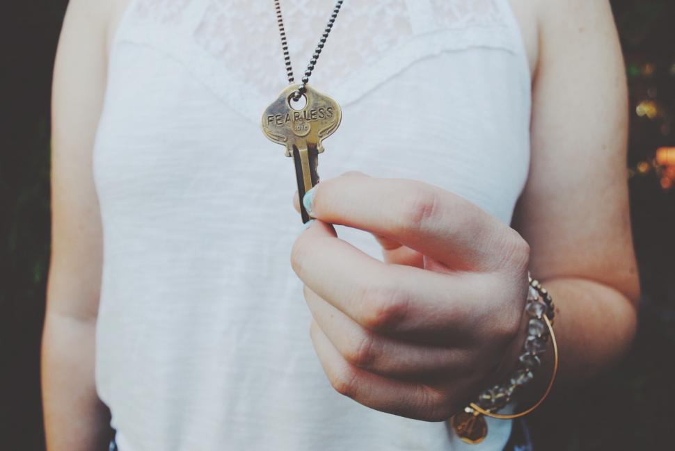 Free Image of Woman holding a key with an empowering message 