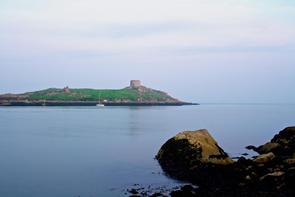 Free Image of Serene seascape with historical tower 