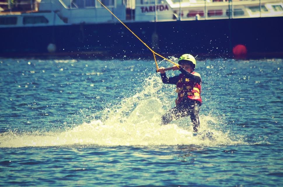 Free Image of Child wakeboarding on sunny day 