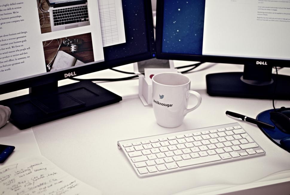 Free Image of Work desk with multiple monitors and a mug 