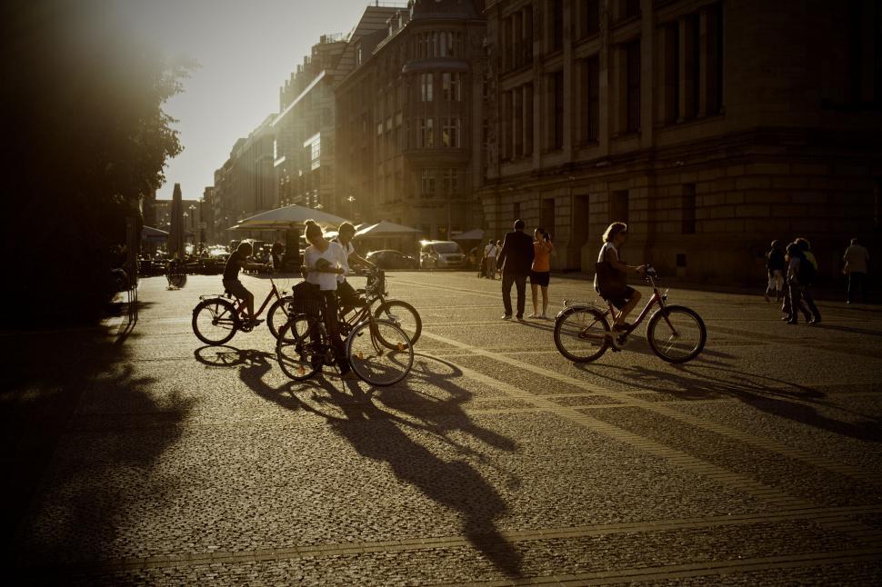 Free Image of Cyclists and pedestrians on sunlit street 