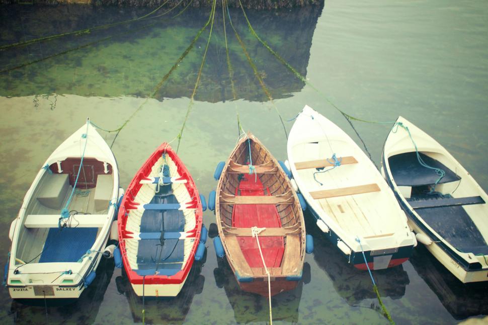 Free Image of Colorful boats docked at a calm waterside 