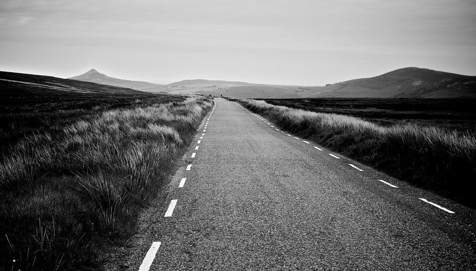 Free Image of An empty road through a moody landscape 