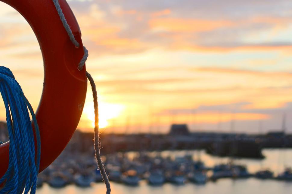 Free Image of Lifebuoy tied on the dock at sunset 