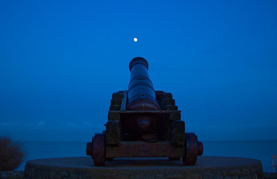 Free Image of Cannon overlooking sea under moonlight 