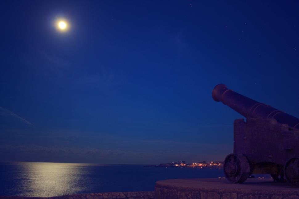 Free Image of Cannon overlooking the sea under moonlight 