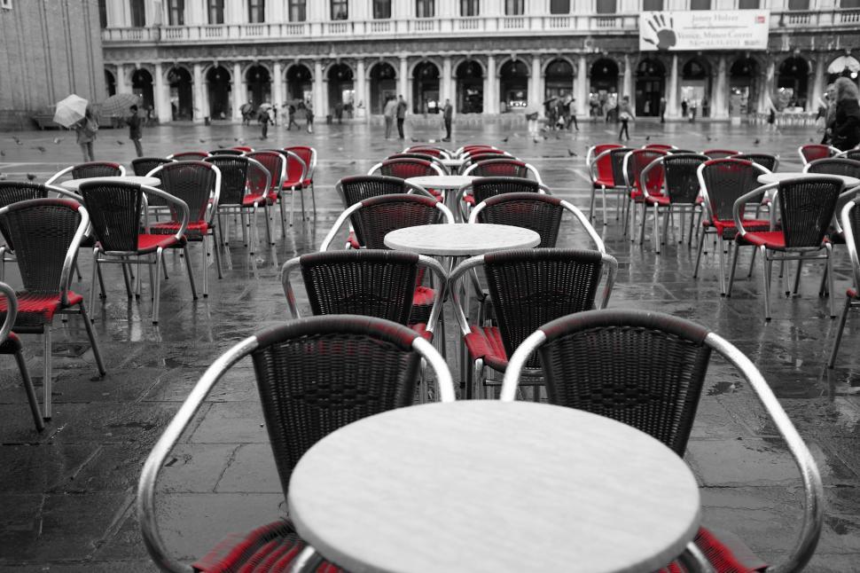 Free Image of Empty red chairs at outdoor cafe in rain 