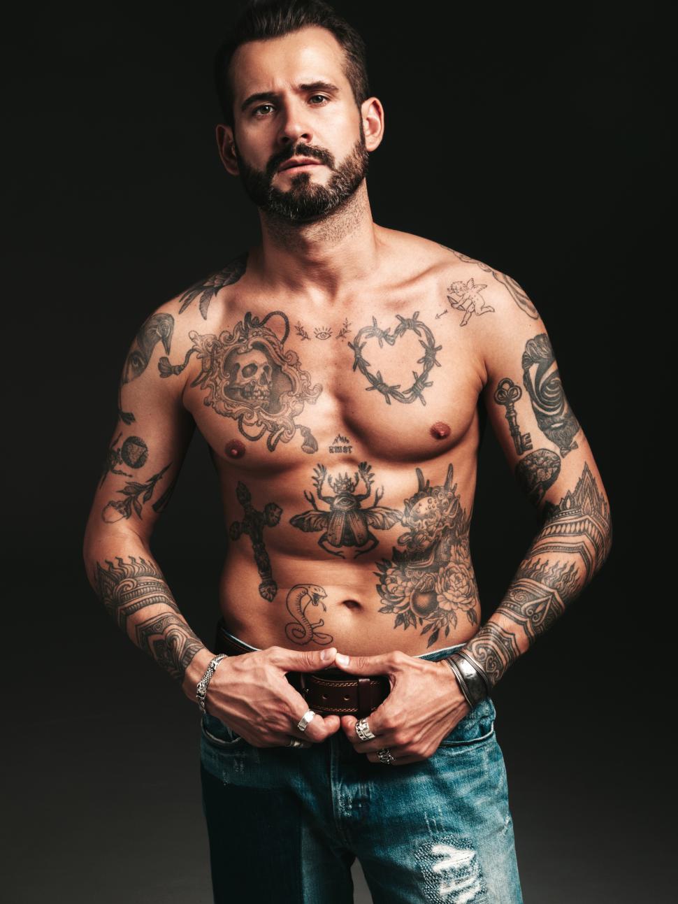 Free Image of A man with tattoos on his chest 