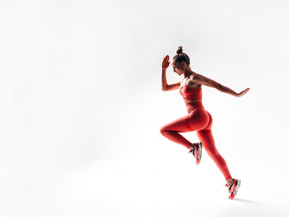 Free Image of A woman in red outfit running 
