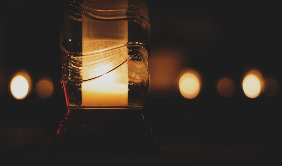 Free Image of Warm candle light glowing in the darkness 
