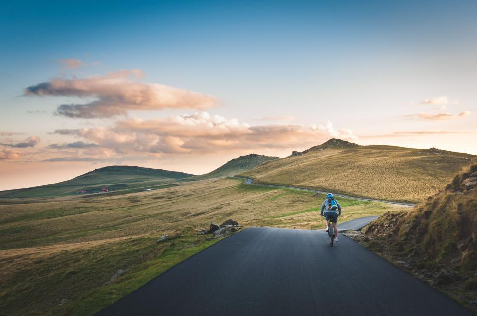 Free Image of Cyclist on a scenic country road 
