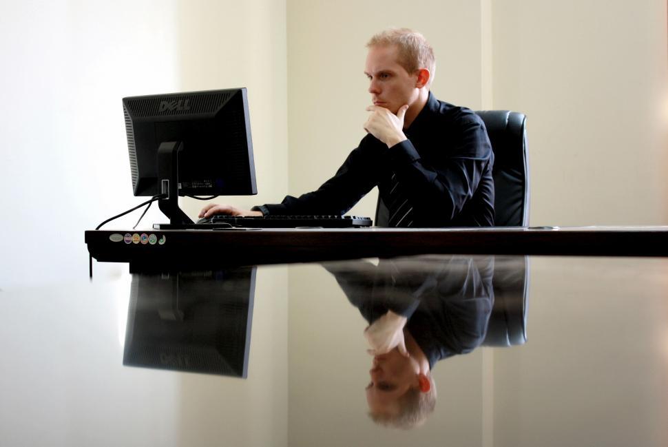 Free Image of Man working on computer with reflection 