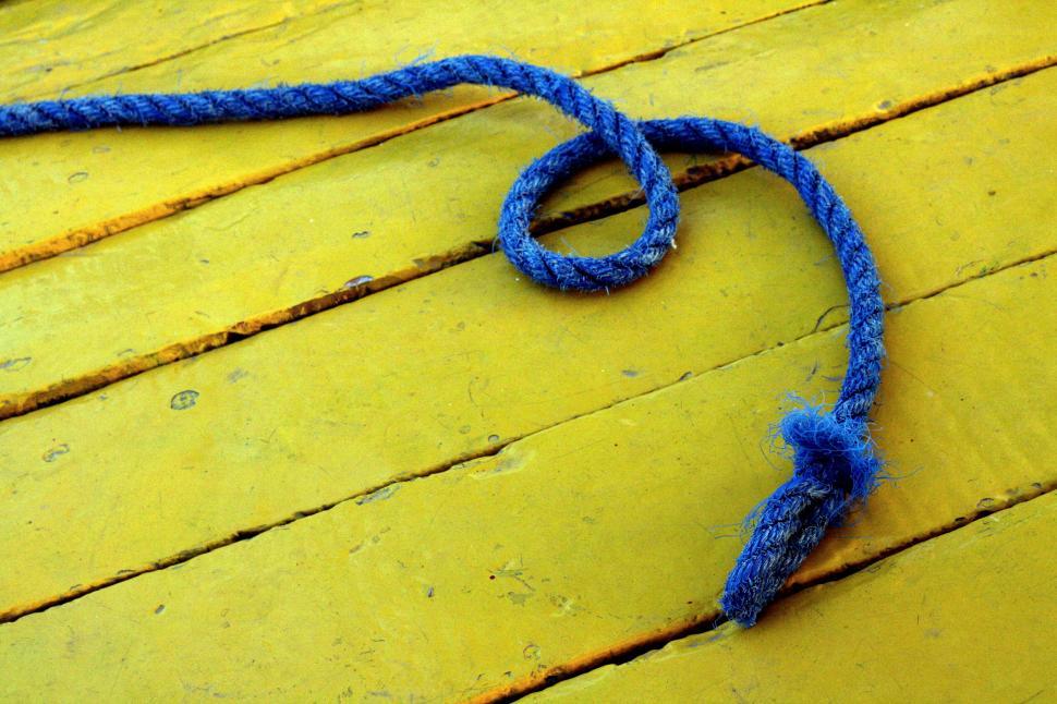 Free Image of Blue rope on yellow wooden surface 