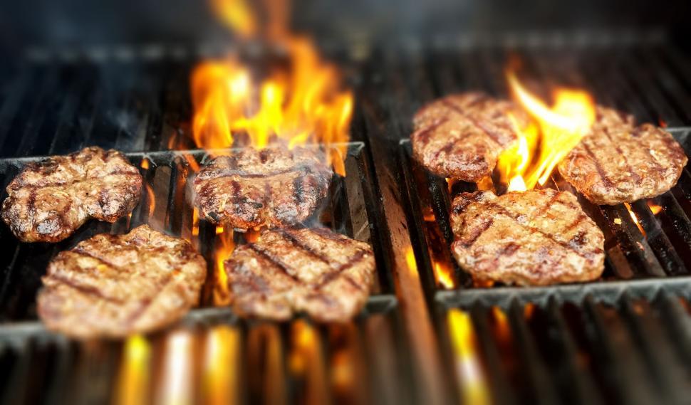 Free Image of Juicy steaks on a flaming grill 