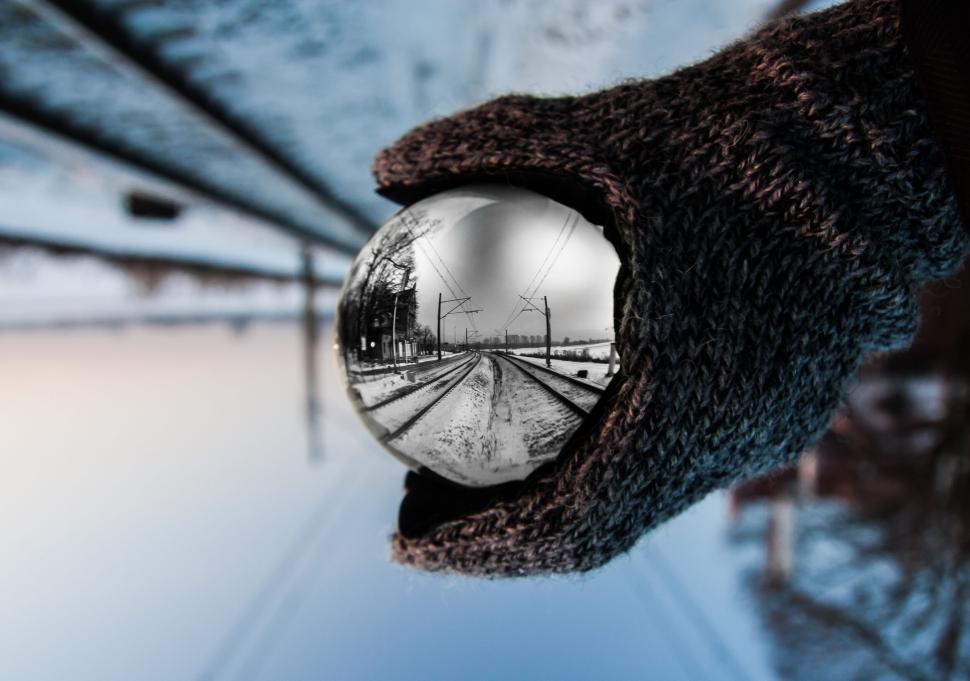 Free Image of Crystal ball reflecting winter railroad tracks 