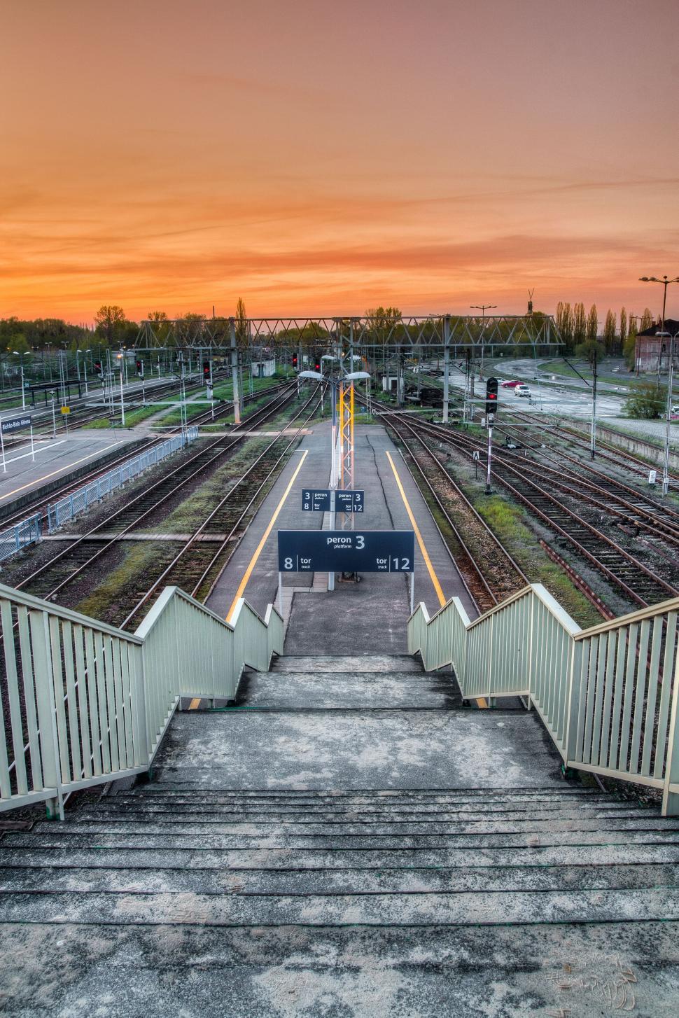 Free Image of Sunrise over a tranquil railway station 