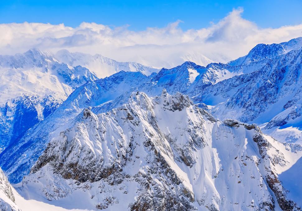 Free Image of Aerial view of jagged snow-covered mountain peaks 