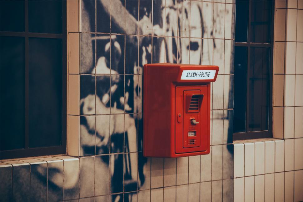 Free Image of Vintage alarm box on a tiled wall 