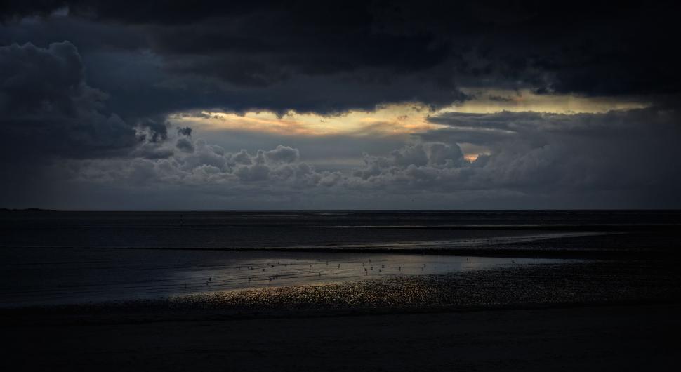 Free Image of Moody beachscape with dramatic clouds 
