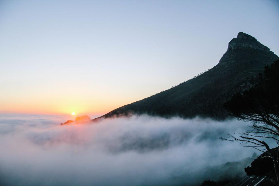 Free Image of Mountain peak with sunset and foggy base 