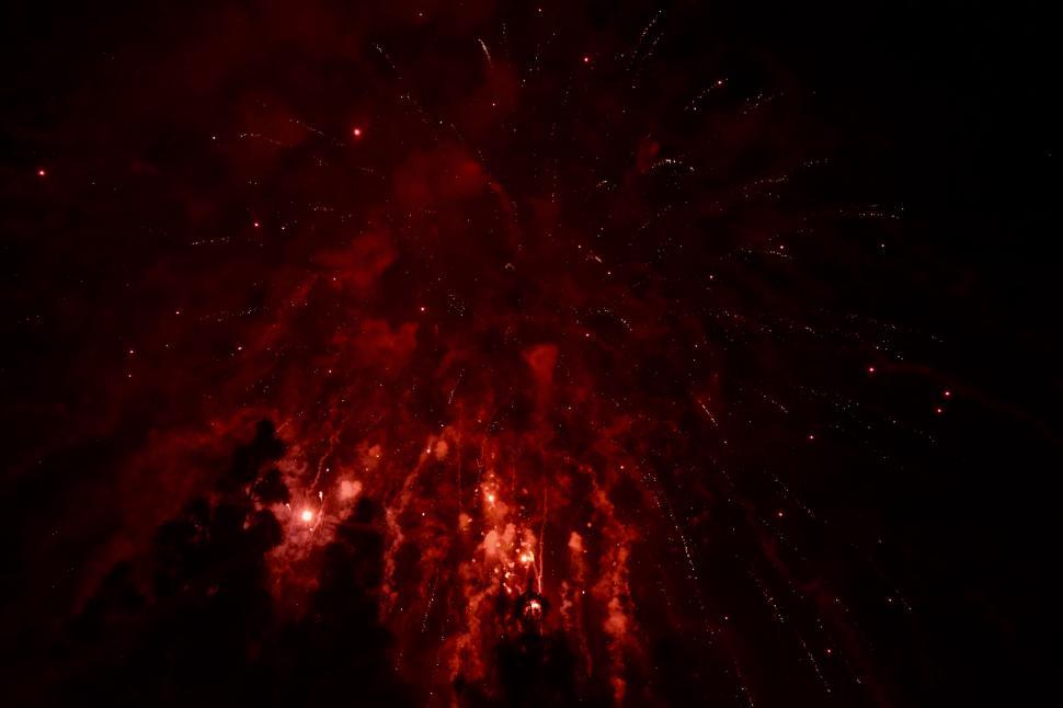 Free Image of Fiery red fireworks exploding in black sky 