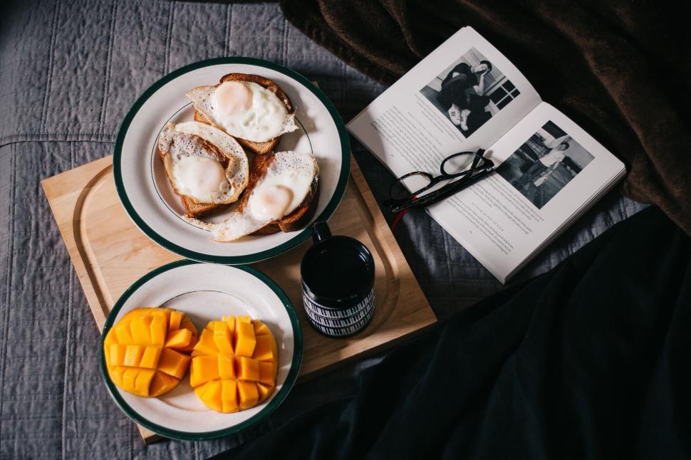Free Image of Cozy breakfast setup with book and spectacles 
