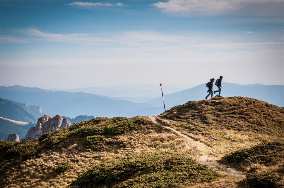 Free Image of Hikers on a mountain trail with scenic view 