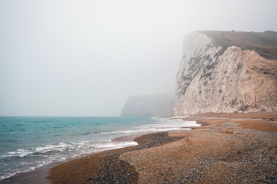 Free Image of Misty beach with chalk cliffs 