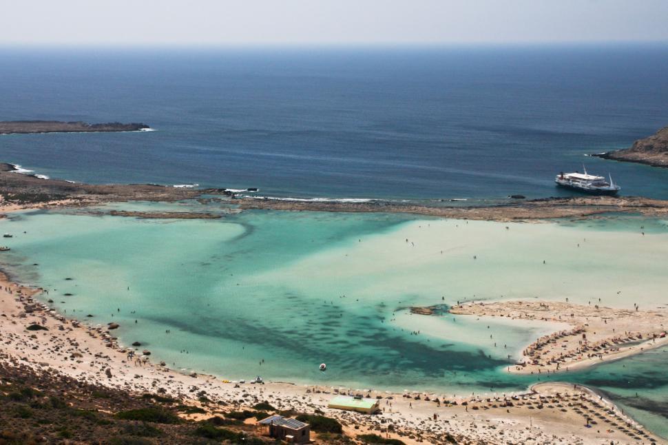 Free Image of Turquoise lagoon bordered by a rocky beach 