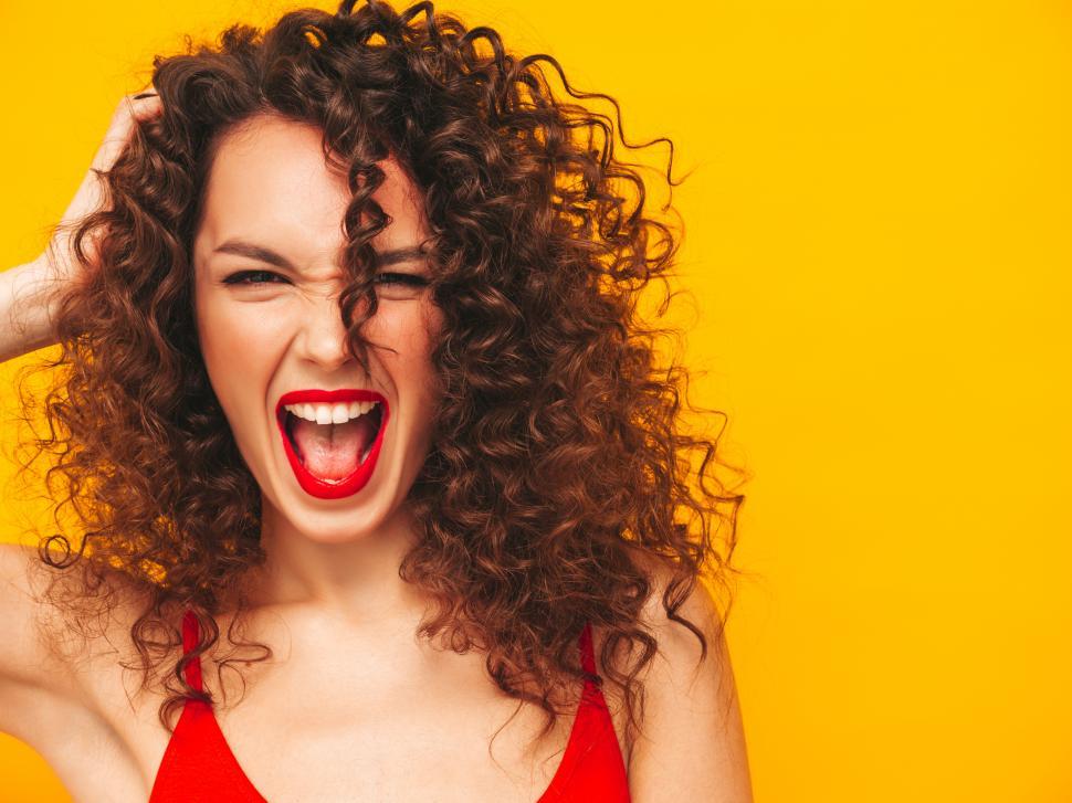Free Image of A woman with curly hair and red shirt 