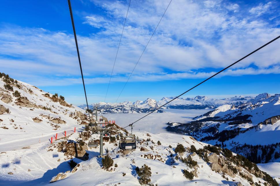 Free Image of Snowy mountain cable car over scenic landscape 