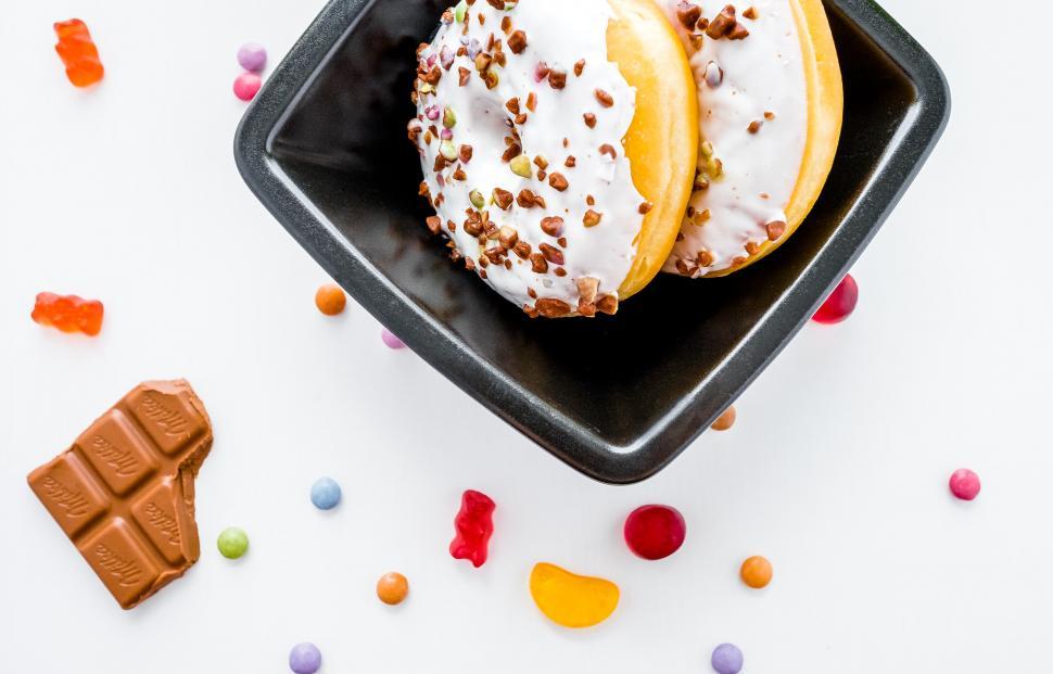 Free Image of Donuts with white icing and colorful sprinkles 