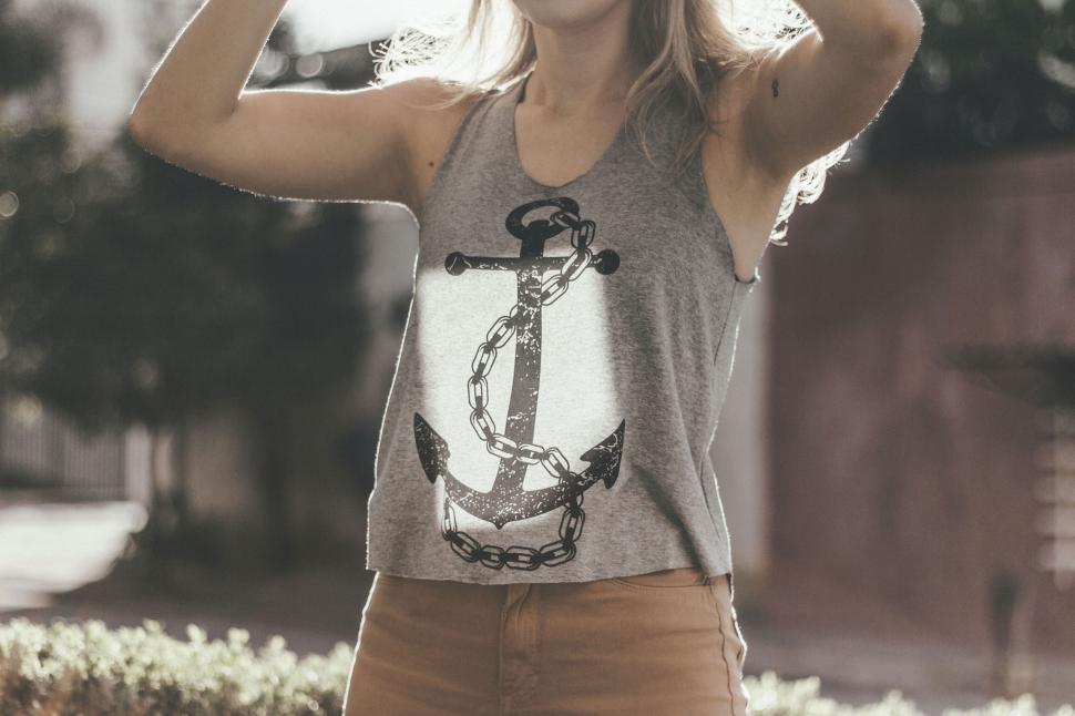 Free Image of Woman in casual attire with stylish anchor tank top 