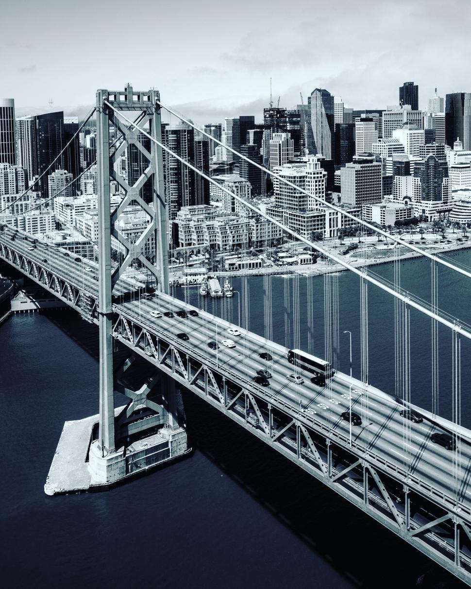 Free Image of Black and white shot of a bridge and city 