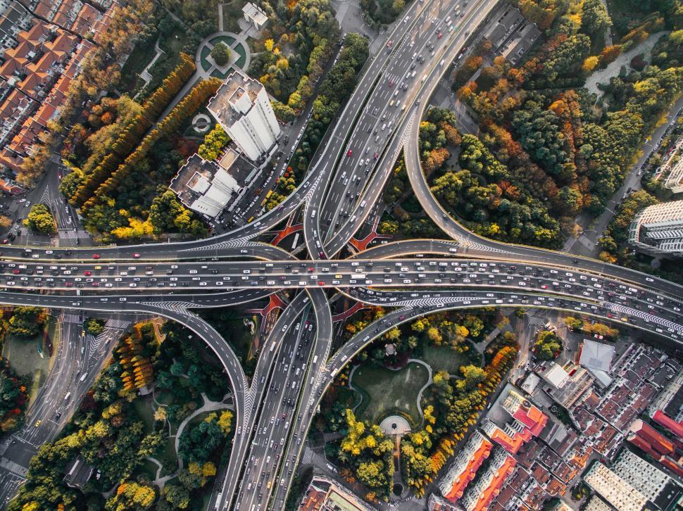 Free Image of Overhead shot of complex highway interchange surrounded by trees 