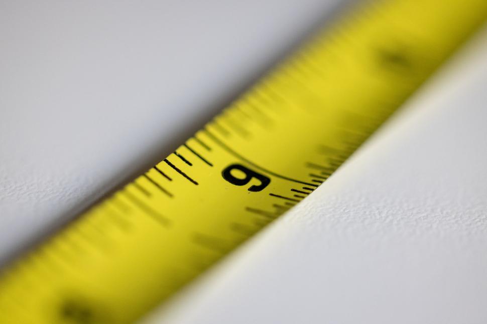 Free Image of Macro shot of a yellow measuring tape 