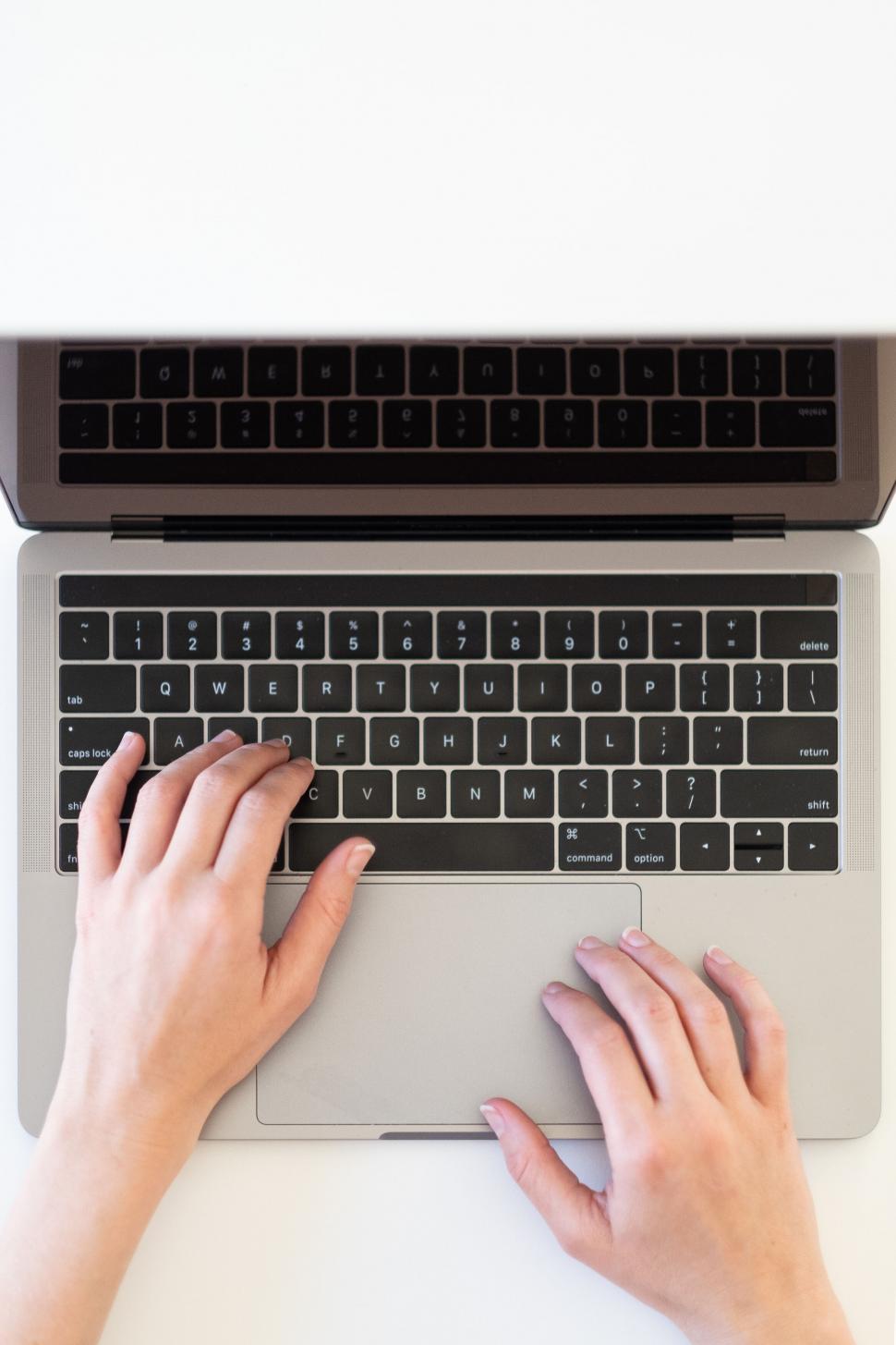 Free Image of Hands typing on a laptop s keyboard 