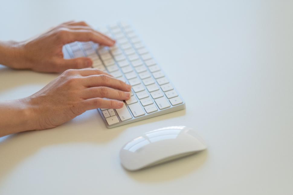 Free Image of Close-up of hands typing on keyboard 